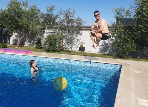 Paul jumping into a pool